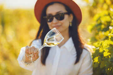 Woman in Hat and Sunglasses Holding Wine Glass and Analysis it Color