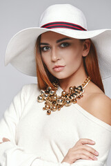 Beautiful woman wearing hat and necklace
