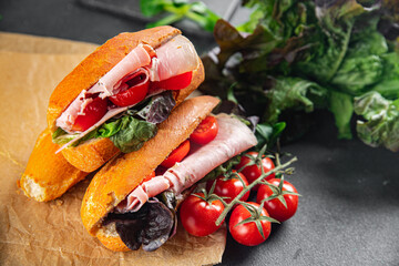 sandwich ham, tomato, green lettuce healthy eating cooking appetizer meal food snack on the table copy space food background rustic top view