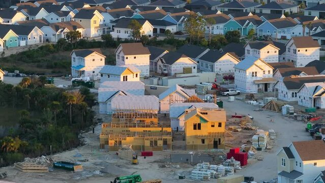 Wooden houses under construction in new developing suburban area. Development of residential housing in American suburbs. Real estate market in the USA.