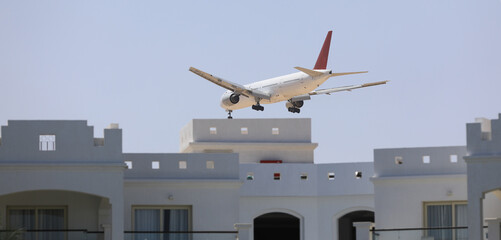 passenger plane lands over a building