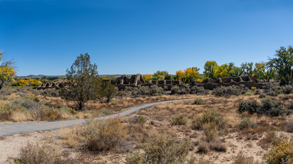 Aztec Ruins National Monument in New Mexico. Best preserved Chacoan structures including Aztec West great house built by ancestral Pueblo people. 400 rooms and three stories, autumn cottonwood trees.