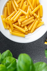 raw pasta tortiglioni cooking appetizer meal food snack on the table copy space food background rustic top view