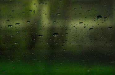 water drops on glass on a green background