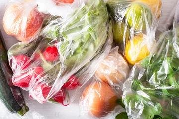 Poster single use plastic waste issue. fruits and vegetables in plastic bags © Olga Miltsova