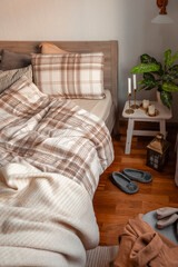 cozy scandinavian bedroom interior in natural tones, real life mess disorder