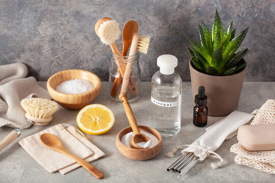 zero waste eco friendly cleaning kitchen concept. wooden brushes, lemon, baking soda, vinegar, drinking straw