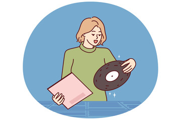 Woman chooses vinyl record standing in store for retro music collectors and analog audio lovers. Girl is looking for classical music from favorite composer at used vinyl record fair - 785547111