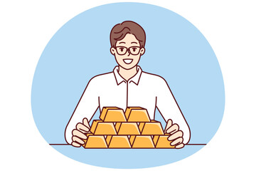 Businessman with gold bars sitting at table and smiling looking at camera for precious metals investment. Man investor with gold bars avoiding inflation and symbolizing diversification of assets