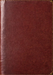 The dark red leather cover of an old book, slightly worn, devoid of any text or decoration, serious and alluring.
