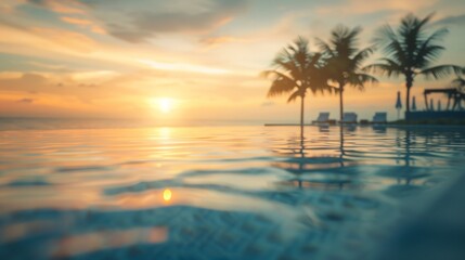 Blurred view of a luxurious hotel pool overlooking a paradisiacal beach at sunset with no one in the image 03