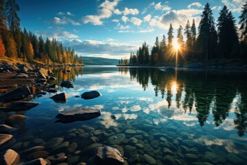 Sunlight shines through clouds onto a lake surrounded by rocks and trees