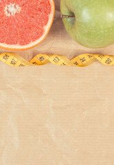 Ripe fruits and tape measure. Healthy lifestyle. Fruits as source minerals and vitamins. Place for text