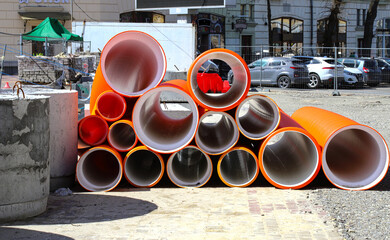 Materials for the repair of water pipes were collected on the square. Plastic large orange pipes,...