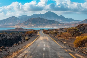 Wandcirkels plexiglas Image related to unexplored road journeys and adventures. Road through the scenic landscape to the destination in Lanzarote natural park © Zoraiz