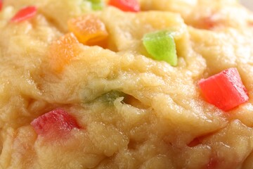 Texture of raw dough with candied fruits as background, closeup