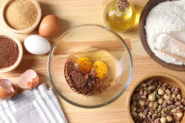 Ingredients for homemade dough on wooden table, flat lay
