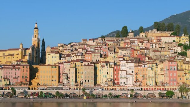 Aerial: As The Sun Rises, It Paints A Picturesque Mediterranean Town In A Spectrum Of Warm Colors, With A Church Spire Dominating The Skyline. - Menton, France