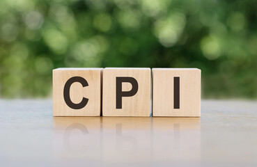 Wooden blocks arranged to spell out the acronym CPI on a table.