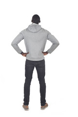 back view of a man standing , amrs akimbo and look up on white background - 785571339