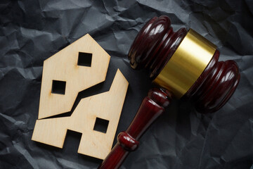 Divided house and gavel. Division of real estate in case of divorce or inheritance. - obrazy, fototapety, plakaty