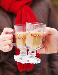 Couple holding cups of hot chocolate outdoors
