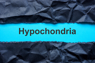Torn black paper and word hypochondria.