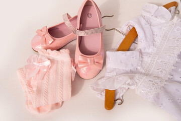 Beautiful fancy pink sparkly shoes with bows for little girl, lacy socks to match, white dress,...