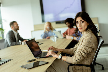 Radiant professional woman excels during a dynamic office meeting in bright workspace