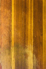 Obraz premium A close-up of weathered wood planks arranged vertically, revealing a detailed texture rich with variations in color and tone.