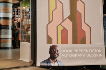 Part of poster representing popular writer and his autograph session during meeting with readers in modern library