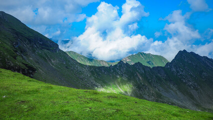 View above Fagaras Ridges. Dramatic sky with clouds and fog covering the mountain steep and rocky...