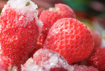 frozen red strawberries with ice close-up