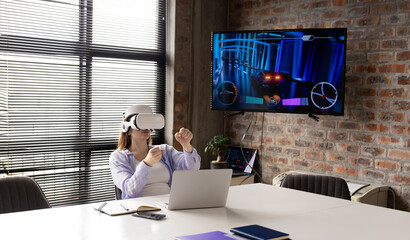 Caucasian young professional wearing VR headset, playing game in a modern business office