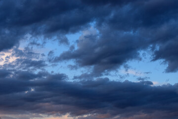 Naklejka na ściany i meble Blue dark clouds in the sky before the rain, evening, twilight