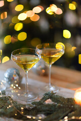 Glasses of sparkling wine on wooden table on Christmas