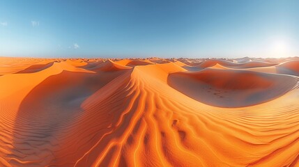   A sizable collection of sand dunes against a backdrop of vibrant blue sky, with the sun prominently positioned at its zenith
