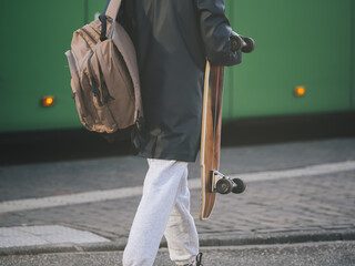 Urban Skater Carrying Skateboard and Backpack