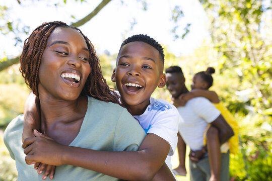 African American family enjoying outdoors, young boy hugging mother