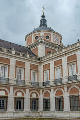 Fototapeta na wymiar Corner with windows. balconies and dome from one of the patios of the royal palace of Aranjuez in Aranjuez, province of Madrid. Spain