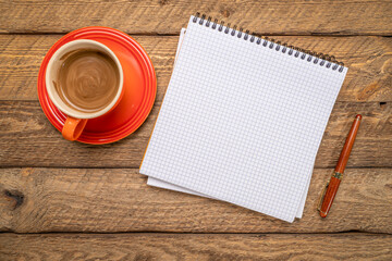 blank spiral notebook with grid paper, flat lay with coffee and pen on on weathered barn wood - 785611576