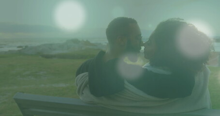 Naklejka premium Image of light spots over african american couple at beach