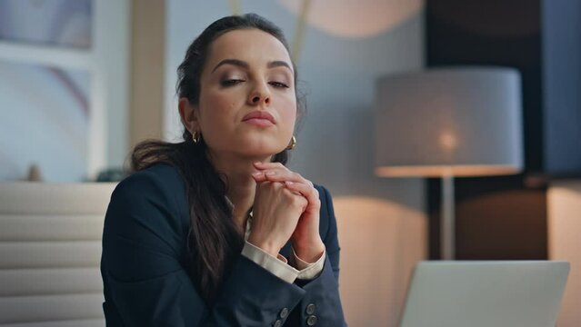 Thoughtful office employee posing workplace looking camera thinking portrait