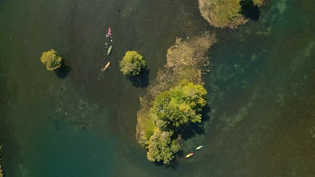 Top down Aerial video of Rainbow River, people kayaking and boating. Dunnellon, Florida, USA. South of Ocala, FL.  April 15, 2024.