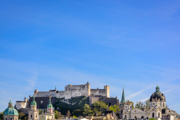 Background with a view of Salzburg and a blue sky with the Hohensalzburg fortress in the distance