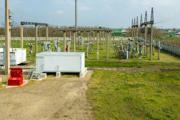 Power transformer and equipment against the background of a high voltage substation.