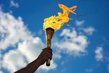 An individual proudly lifts the blazing Olympic torch