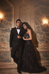 Elegantly dressed couple in a luxurious setting