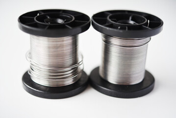 Tin-lead solder in coils on a white background. Materials for soldering.