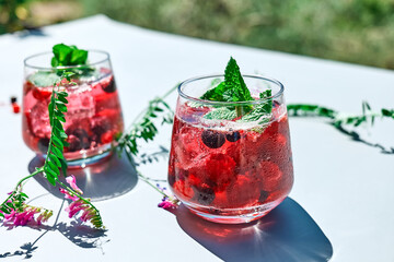 Berry refreshing cold summer drink. Cocktail or mocktail with ripe seasonal berries and mint. Detox...